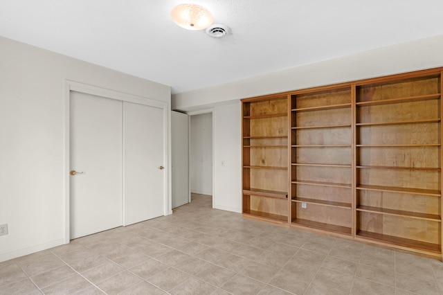unfurnished bedroom with visible vents and a closet