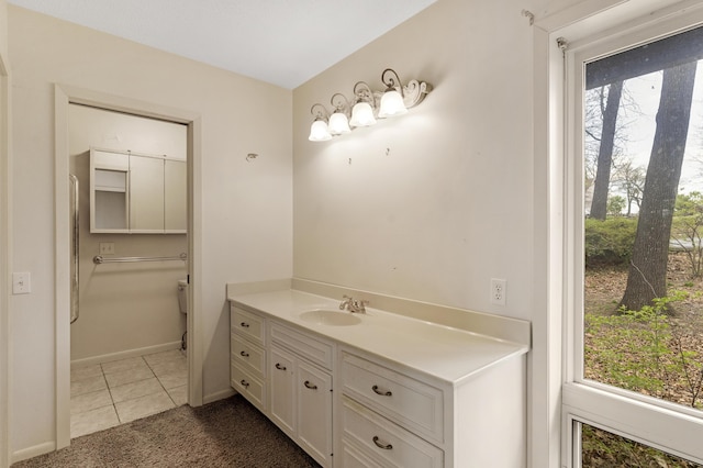 bathroom with baseboards and vanity