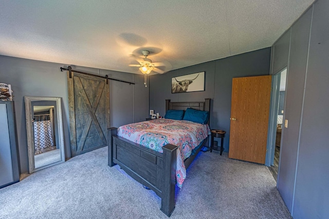 15601 County Road 281, Wheatland, MO 65779 - carpeted bedroom featuring a barn door, access to outside, a textured ceiling, and a ceiling fan