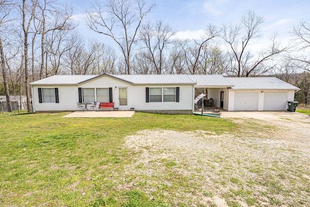 15601 County Road 281, Wheatland, MO 65779 - view of front of home featuring driveway, a front yard, a patio area, metal roof, and fence