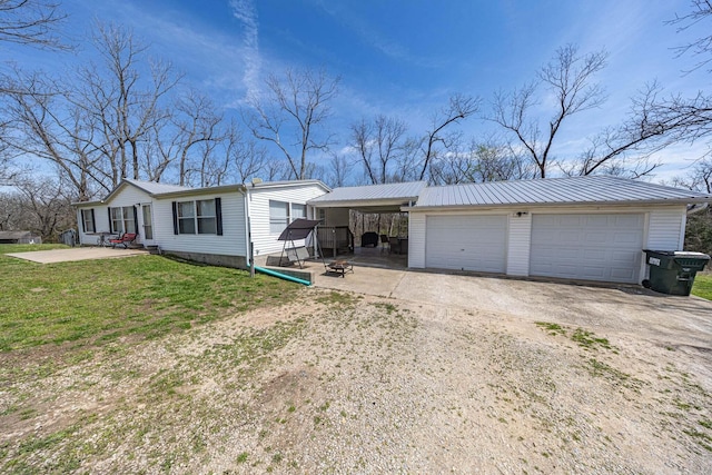 15601 County Road 281, Wheatland, MO 65779 - ranch-style house with a front yard, metal roof, a detached garage, and dirt driveway