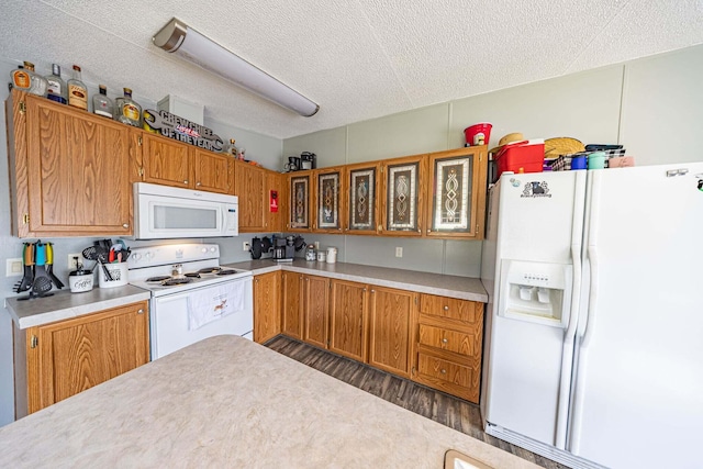 15601 County Road 281, Wheatland, MO 65779 - kitchen featuring white appliances, light countertops, a textured ceiling, brown cabinets, and wood finished floors