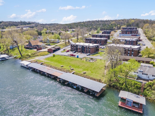 birds eye view of property with a forest view and a water view