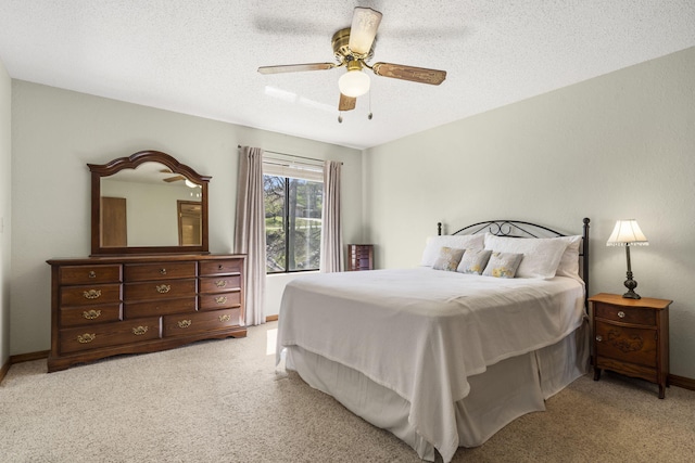bedroom featuring carpet flooring, baseboards, a ceiling fan, and a textured ceiling
