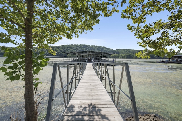 dock area featuring a water view and a forest view