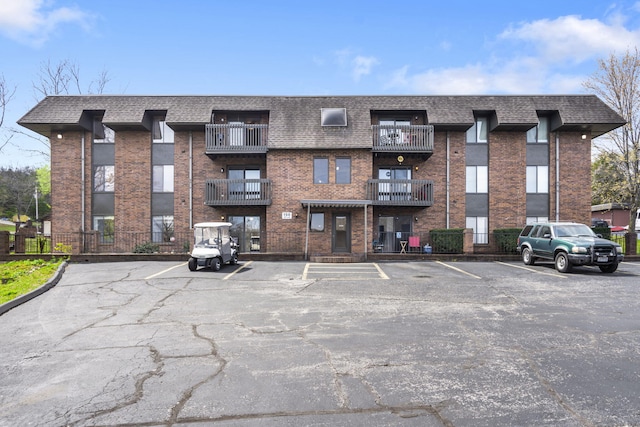 view of building exterior with uncovered parking