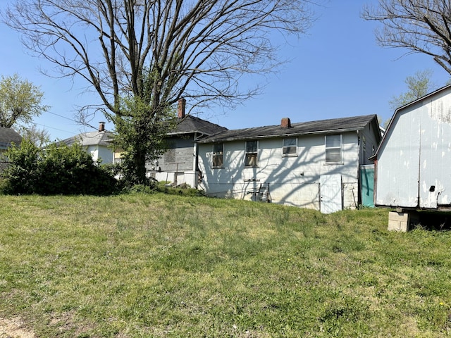 exterior space featuring a yard and a chimney