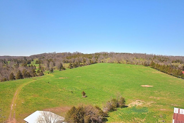 aerial view with a rural view and a wooded view