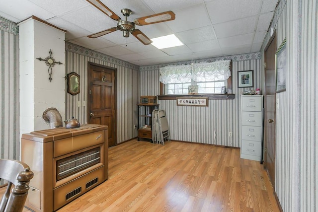 miscellaneous room featuring light wood finished floors, a paneled ceiling, wallpapered walls, and ceiling fan
