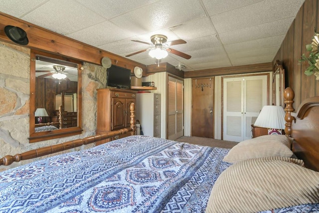 bedroom featuring multiple closets, a ceiling fan, and carpet