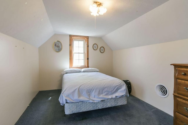 bedroom with lofted ceiling, carpet, and visible vents