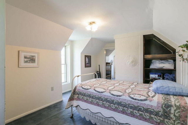 bedroom with baseboards, carpet, and lofted ceiling