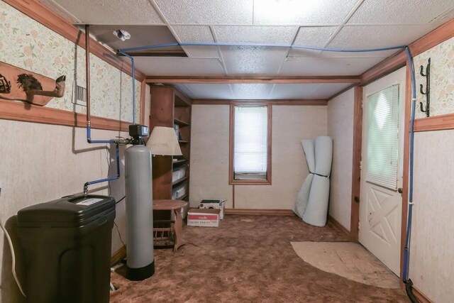 basement featuring carpet flooring and wallpapered walls