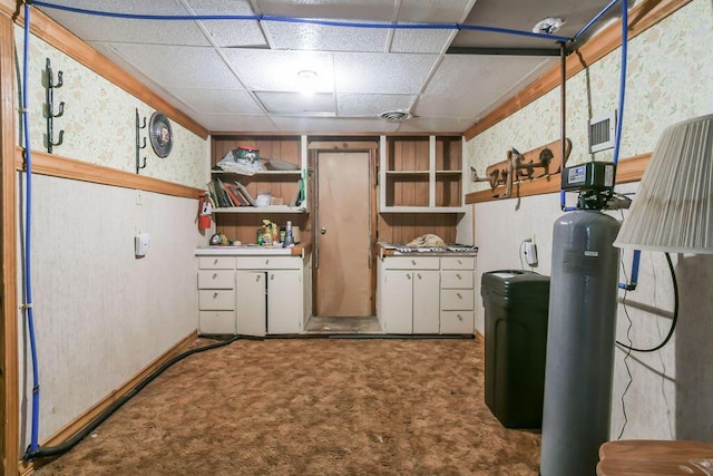 finished basement with a paneled ceiling and carpet flooring