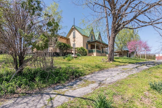 exterior space featuring driveway, stucco siding, and a front lawn