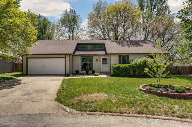 view of front of house with a garage, a front lawn, concrete driveway, and fence