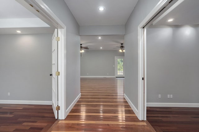 hall featuring recessed lighting, baseboards, and wood finished floors