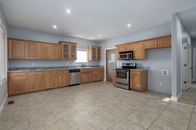 kitchen with visible vents, a sink, appliances with stainless steel finishes, brown cabinets, and recessed lighting