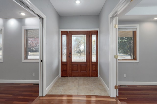 foyer entrance with light wood-style flooring, baseboards, visible vents, and recessed lighting