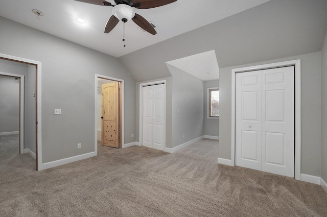 unfurnished bedroom with multiple closets, carpet, and baseboards