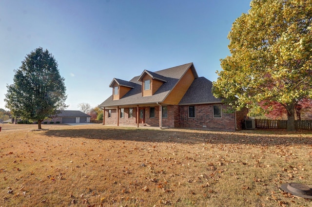 view of side of home with central AC unit, a detached garage, fence, brick siding, and roof with shingles