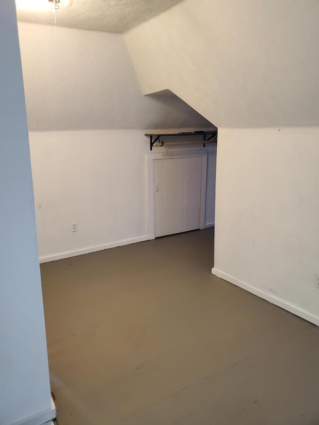 2111 N Grant Ave, Springfield, MO 65803 - bonus room featuring finished concrete flooring, baseboards, and vaulted ceiling