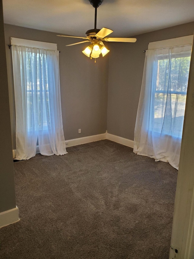 2111 N Grant Ave, Springfield, MO 65803 - empty room with ceiling fan, dark colored carpet, and baseboards