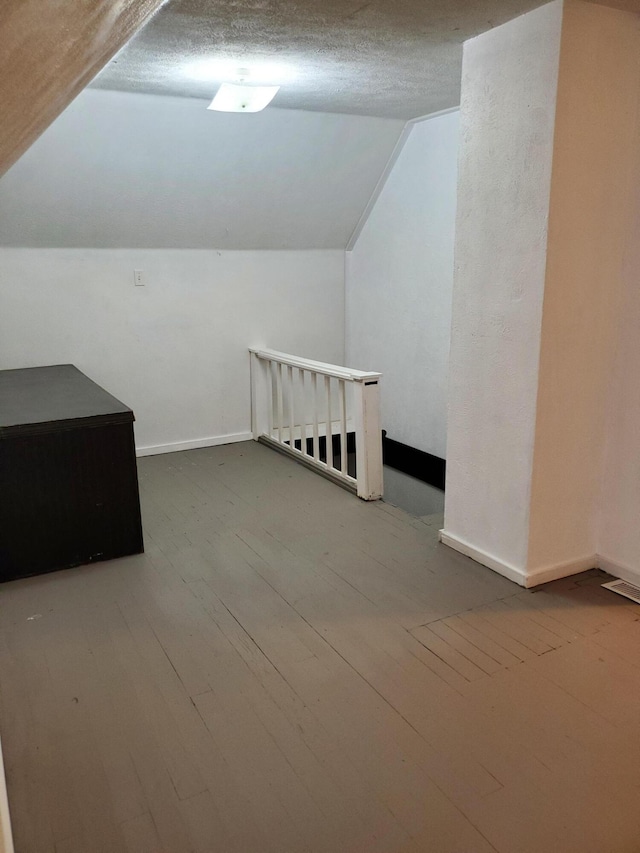 2111 N Grant Ave, Springfield, MO 65803 - additional living space featuring hardwood / wood-style flooring, baseboards, and lofted ceiling