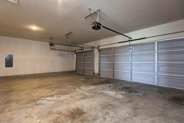 garage with a garage door opener, baseboards, and electric panel