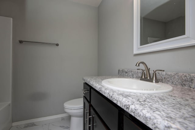 full bath with vanity, baseboards, a bathtub, toilet, and marble finish floor