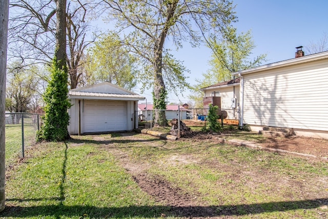317 W 1st St, Miller, MO 65707 - view of yard with an outbuilding, dirt driveway, fence, and a garage