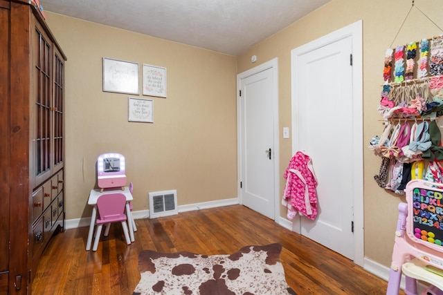 317 W 1st St, Miller, MO 65707 - recreation room featuring visible vents, baseboards, and wood finished floors