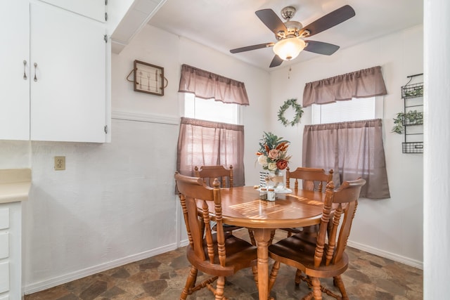 317 W 1st St, Miller, MO 65707 - dining area with baseboards, a ceiling fan, and stone finish flooring