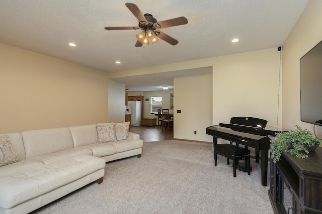 1431 Isdell St, Bolivar, MO 65613 - living room featuring light colored carpet, recessed lighting, ceiling fan, baseboards, and a textured ceiling