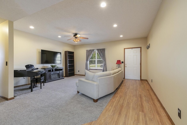 1431 Isdell St, Bolivar, MO 65613 - living room with recessed lighting, ceiling fan, baseboards, light wood finished floors, and light carpet