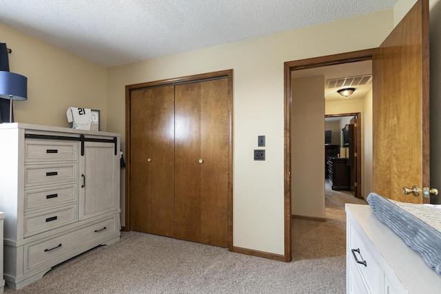 1431 Isdell St, Bolivar, MO 65613 - bedroom with a closet, light carpet, a textured ceiling, and baseboards