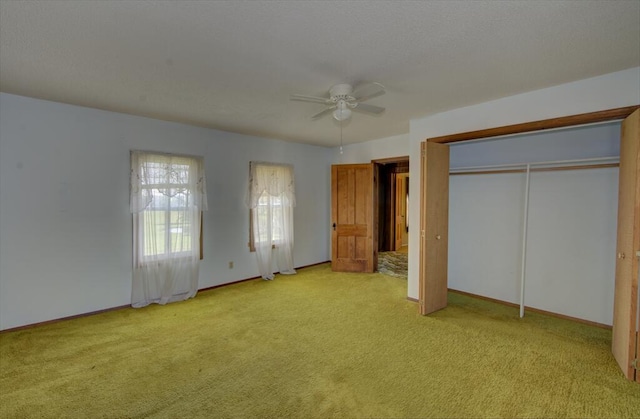 unfurnished bedroom with ceiling fan, light colored carpet, and baseboards
