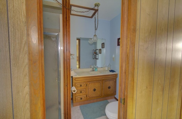 full bathroom featuring toilet, a stall shower, and vanity