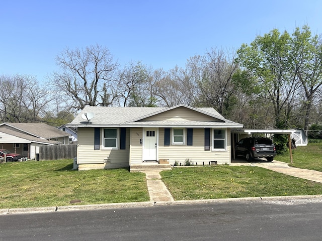 bungalow-style house with a carport, concrete driveway, a front yard, and fence