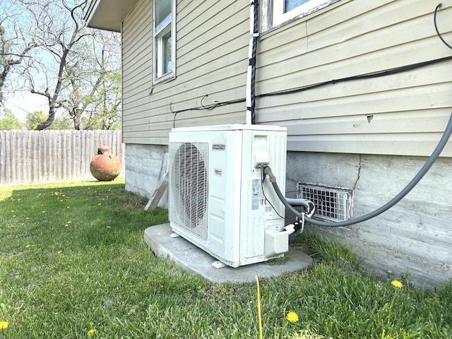details featuring fence and ac unit