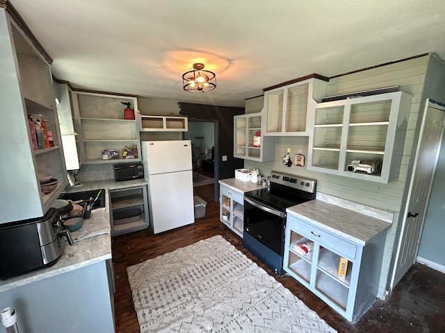 kitchen with open shelves, black microwave, freestanding refrigerator, and stainless steel electric range
