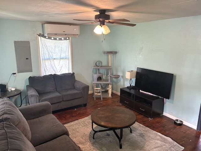 living area featuring ceiling fan, electric panel, wood finished floors, a wall mounted air conditioner, and baseboards