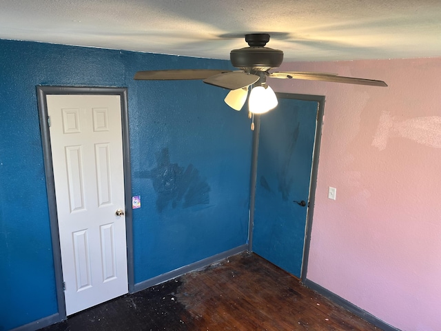 empty room featuring wood finished floors and ceiling fan