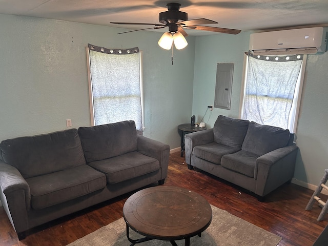 living room featuring a wall mounted air conditioner, electric panel, a textured wall, ceiling fan, and wood finished floors
