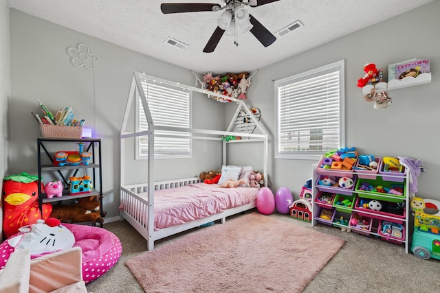 bedroom with multiple windows, visible vents, and carpet floors
