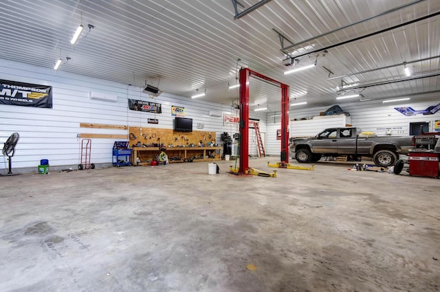 203 E Steel St, Seymour, MO 65746 - garage with a workshop area and a garage door opener