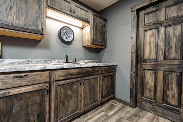 203 E Steel St, Seymour, MO 65746 - bathroom with wood finished floors, vanity, and baseboards