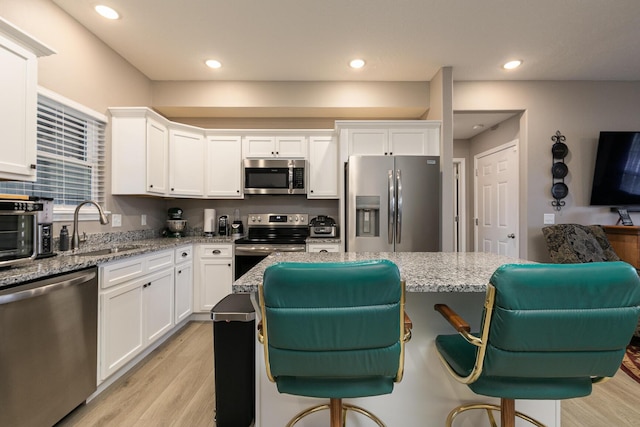 760 W Stewart St, Bolivar, MO 65613 - kitchen featuring appliances with stainless steel finishes, a sink, light wood-style flooring, white cabinetry, and recessed lighting