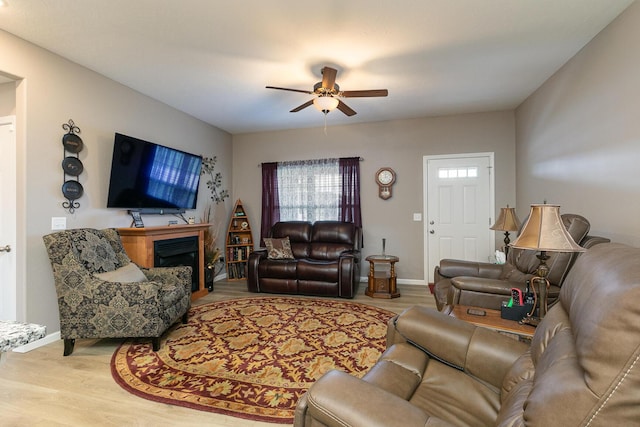 760 W Stewart St, Bolivar, MO 65613 - living area with ceiling fan, wood finished floors, a fireplace, and baseboards