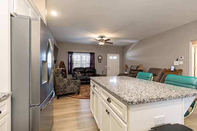 760 W Stewart St, Bolivar, MO 65613 - kitchen with stainless steel fridge with ice dispenser, open floor plan, a ceiling fan, and white cabinets